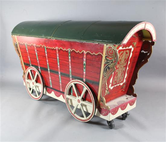 Elisir LAmore: Dr Dulcamaras stage prop carriage from which his assistant pops out, together with a maypole
